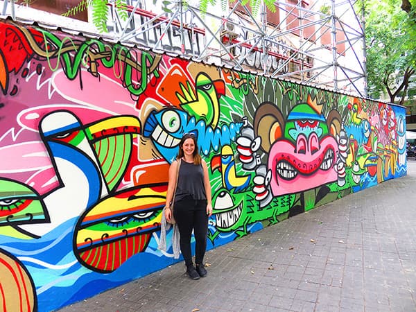 Photo of Laura in front of street art in Barcelona